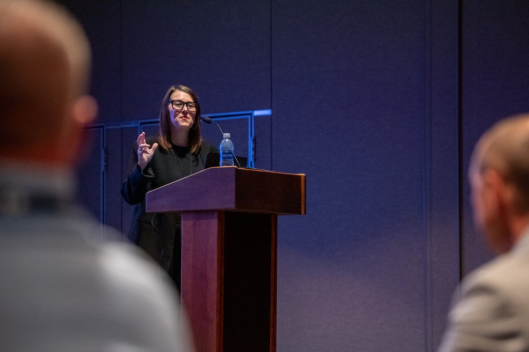 Katie Milton Jordan delivers a keynote address at a VentureFest conference, sharing insights with attendees as part of her personal brand's speaking engagements.